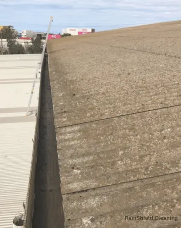 A photo of an industrial side gutter being cleaned in Cincinnati, OH.