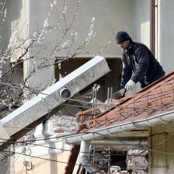 You can see a pro working on the gutter side of a roof in Cincinnati, OH. Our gutter cleaning service ensures debris-free gutters, smooth drainage, and top-quality results.